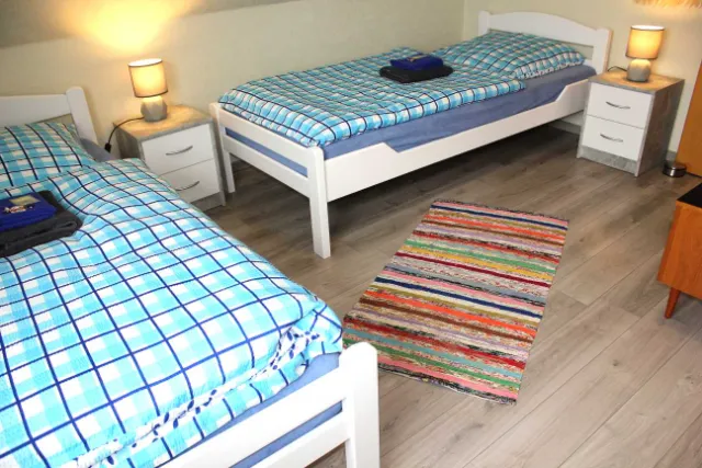 Schlafzimmer mit zwei weißen Einzelbetten